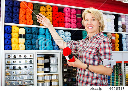Woman picking yarn and wool 44426513