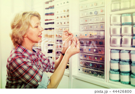 mature woman in sewing store. 44426800