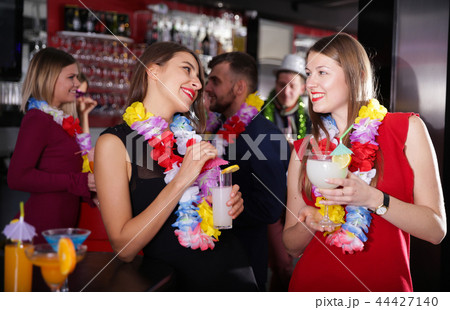 Female colleagues on company party in Hawaiian style in bar 44427140