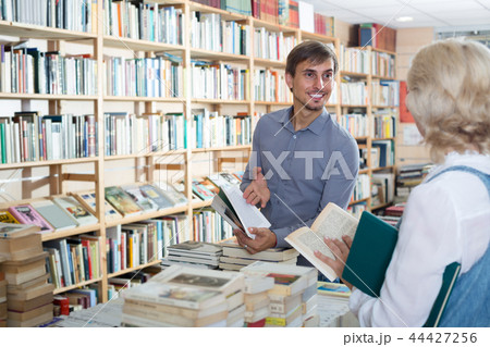 young male seller in book shop. young male seller in book shop. 44427256