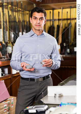 Salesman offering accessories for hunt Salesman offering accessories for hunt 44427352