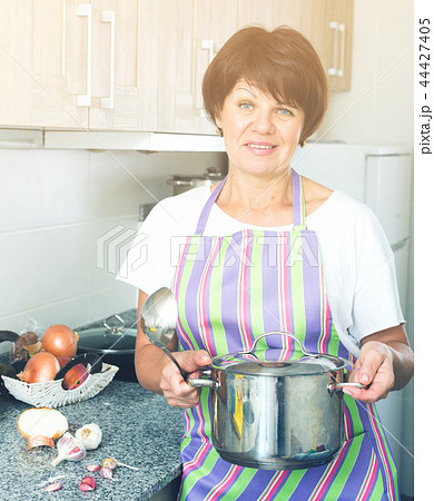 mature woman kitchen soup mature woman kitchen soup 44427405