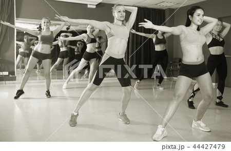 Smiling females are dancing modern jazz 44427479