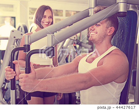 Female assisting man using fly machine Female assisting man using fly machine 44427617