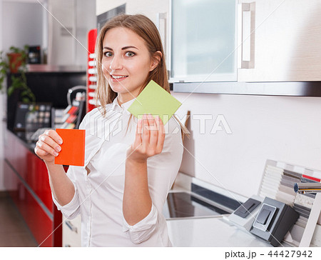 Girl choosing kitchen furniture materials 44427942