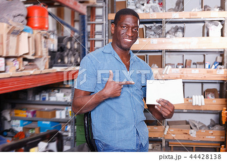 Satisfied African American man recommending ceramic tile in building material store 44428138
