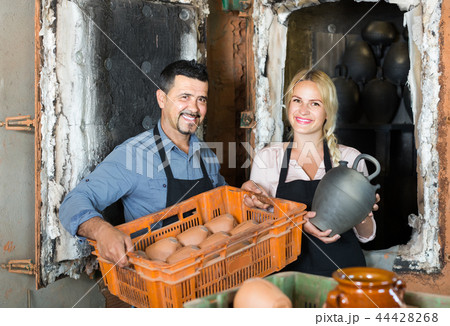 man and woman potters holding ceramic vessels in atelier man and woman potters holding ceramic vessels in atelier 44428268