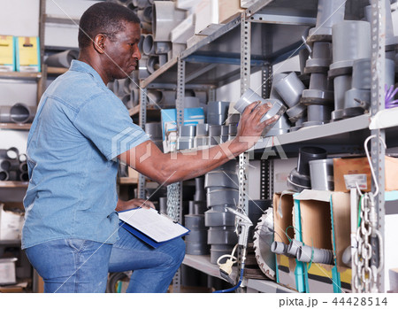 Cheerful African American male making inventory 44428514