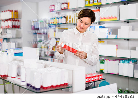 Female is browsing rows of body care products 44428533