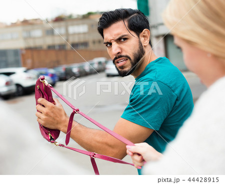 Man is stole the handbag from stranger woman 44428915