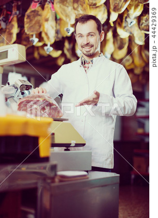 Seller weighing meat Seller weighing meat 44429369
