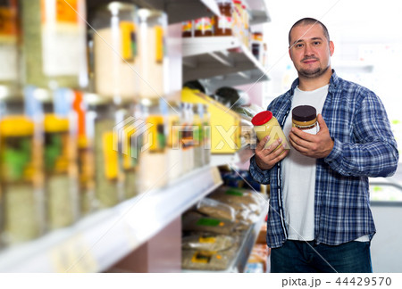 Man purchasing peanut butter in grocery 44429570