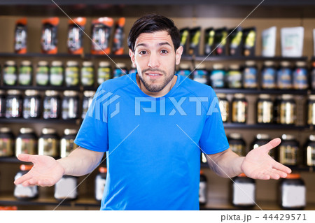 attractive sportman standing in sport nutrition store 44429571