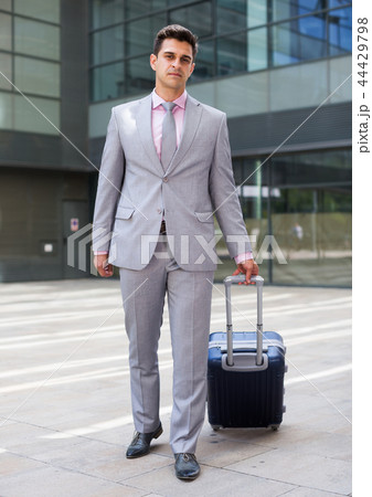 Businessman walking with travel bag 44429798