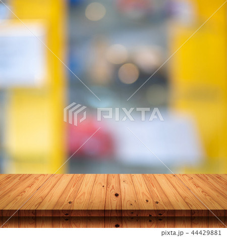 wooden table with blur shopping mall background. wooden table with blur shopping mall background. 44429881