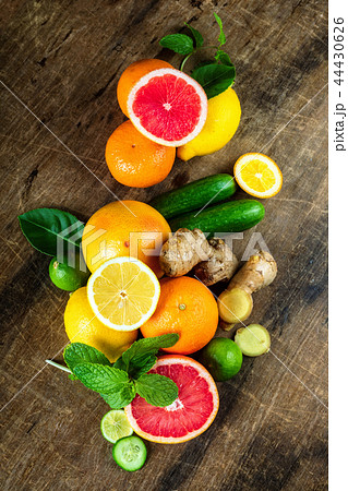 Raw fruit whole and cut on wooden background 44430626