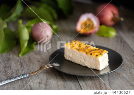 Passion fruits cheese cake slice  on dark plate 44430627