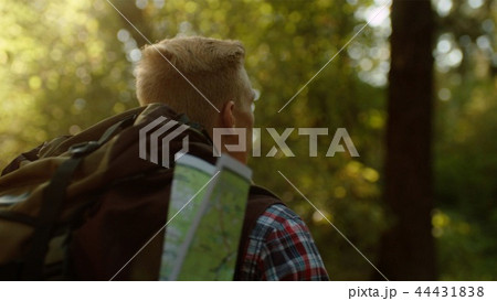 Backshot traveler portrait with huge backpack on hiking in the park 44431838