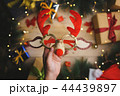 Hand Holding Christmas Reindeer Glasses 44439897