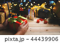 Hand Holding Red Green Christmas Present Gift 44439906