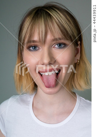 Portrait of a beautiful girl showing the tongue. Portrait of a beautiful girl showing the tongue. 44439911