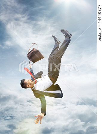 frightened businessman falling down and screaming 44440877