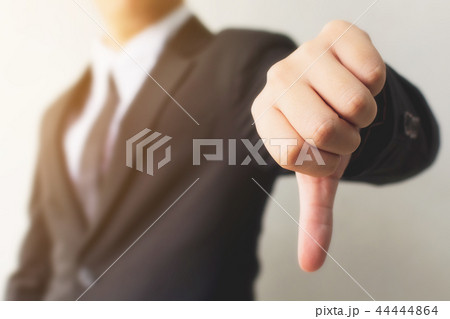 Businessman hand showing thumb down sign gesture Businessman hand showing thumb down sign gesture 44444864