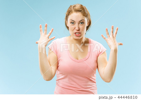 Beautiful female half-length portrait isolated on blue studio backgroud. The young emotional Beautiful female half-length portrait isolated on blue studio backgroud. The young emotional 44446810
