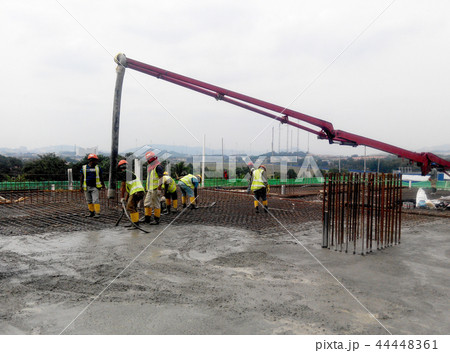 Concreting work by construction workers Concreting work by construction workers 44448361