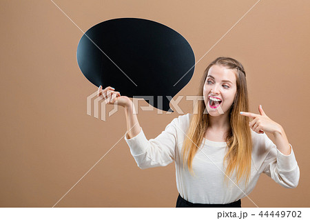 Young woman holding a speech bubble 44449702