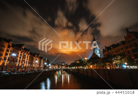 Warehouse district Speicherstadt of Hamburg at night with view from the bridge towards the St 44451018