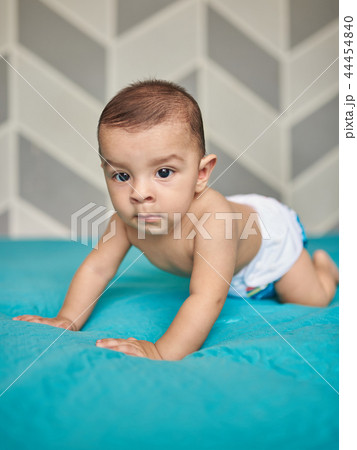 Baby boy on blue bed blanket 44454840