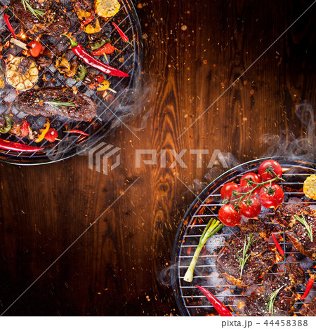 Barbecue grill with beef steaks, close-up. 44458388