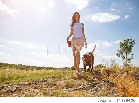 Young woman with her dog walking. Young woman with her dog walking. 44458406