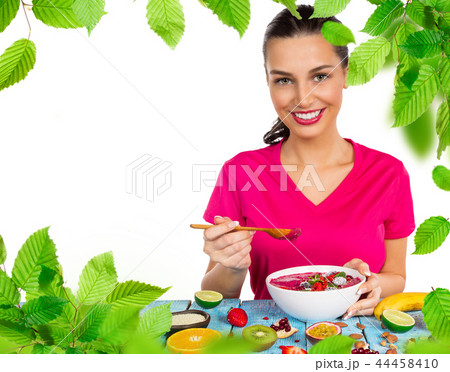 Smoothie bowl with happy young woman. 44458410