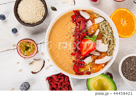 Smoothie bowl with fresh berries, nuts, seeds, fruit and vegetables. 44458421