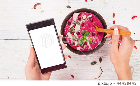 Smoothie bowl with modern cell phone. Smoothie bowl with modern cell phone. 44458445