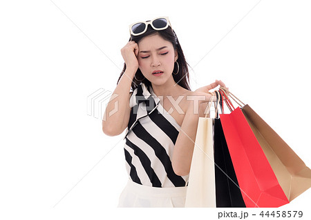 stressed woman holding shopping bag isolated on white background 44458579