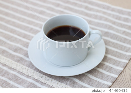A cup of coffee on cute fabric. 44460452