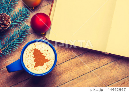 cup of Cappuccino with cream Christmas tree and open book cup of Cappuccino with cream Christmas tree and open book 44462947