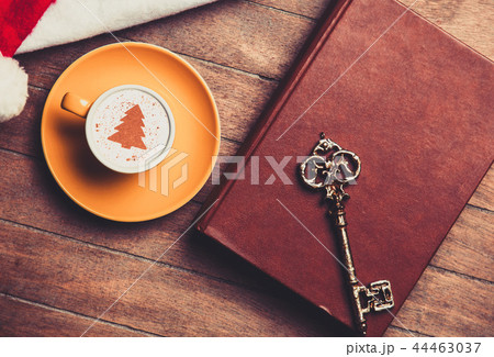 cup of Cappuccino with key and book 44463037