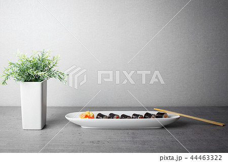 Maki sushi served in long plate on grey table 44463322