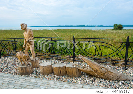 Wooden sculpture of a fisherman on the embankment Wooden sculpture of a fisherman on the embankment 44465317