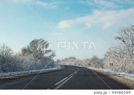 Winter road ahead. Frozen landscape, empty highway Winter road ahead. Frozen landscape, empty highway 44466594