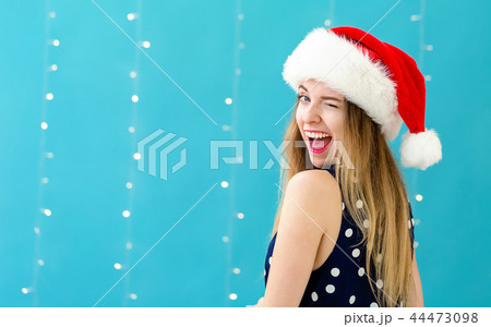 Happy woman with a Santa hat 44473098