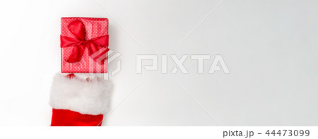 Santa holding a Christmas gift 44473099