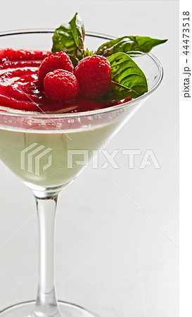 Delicious Italian dessert Panna Cotta with raspberry in small transparent glass 44473518