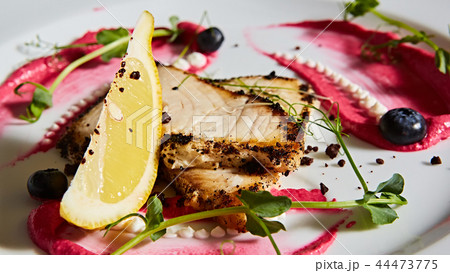 White fish with lemon on white plate, selective focus White fish with lemon on white plate, selective focus 44473775
