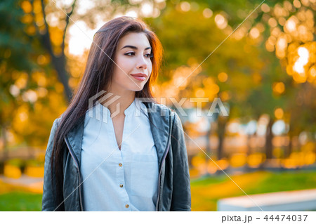Portrait of young happy business woman in the city. Beautiful caucasian student girl in white sexy 44474037
