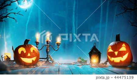 Spooky halloween pumpkins in forest Spooky halloween pumpkins in forest 44475139